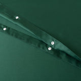 Close-up of Linenly's Bamboo Quilt Cover - Evergreen, featuring a deep green sateen weave with two folded layers. The fabric boasts a smooth texture and shiny metallic buttons along the folds, highlighting its premium bamboo material.