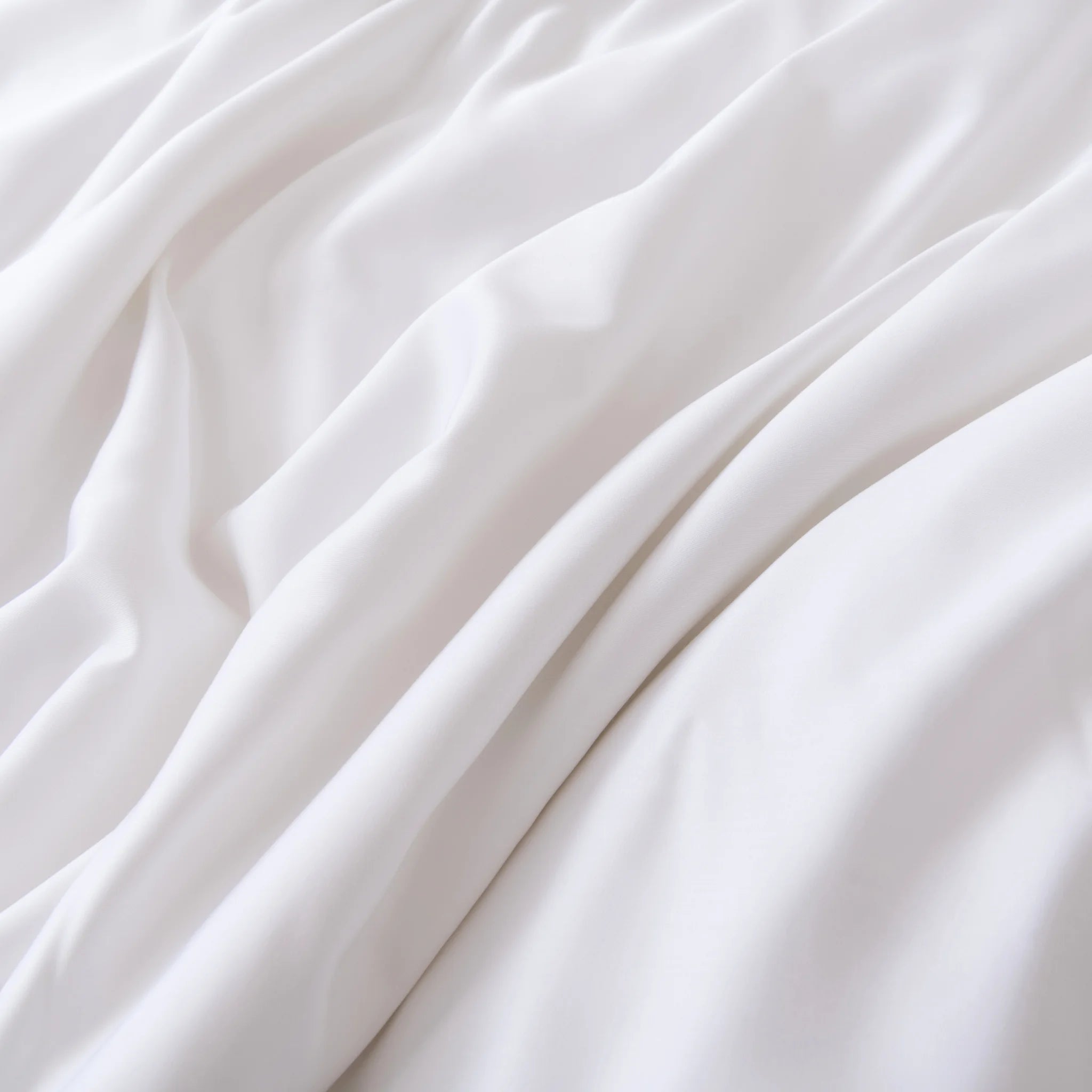 The Linenly Bamboo Pillowcase Set in White features soft, organic bamboo fabric with a smooth texture and gentle folds, offering a calming sense of comfort.